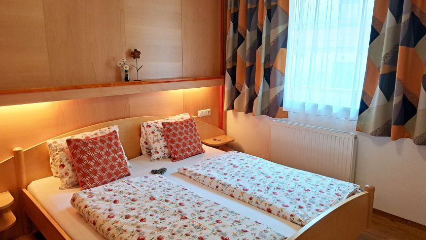 Gemütliches Schlafzimmer mit Doppelbett in den Alpenland Appartements